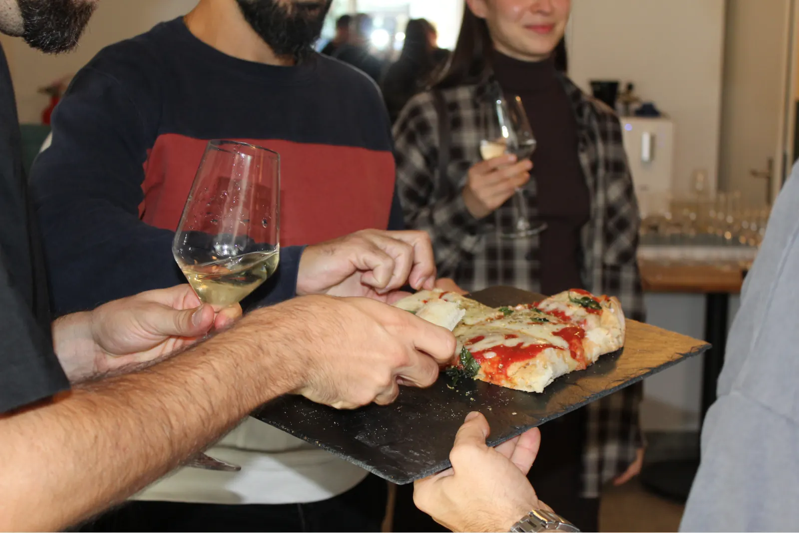 Pizza and wine being passed around